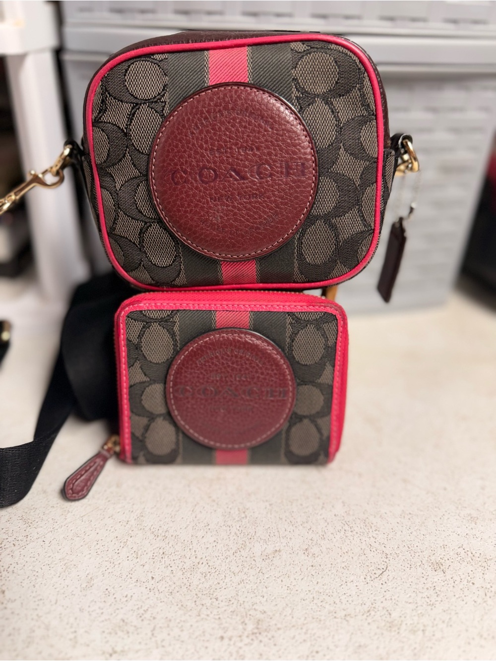 Coach Mini Dempsey Brown Signature Canvas Crossbody with Pink Trim and wallet.